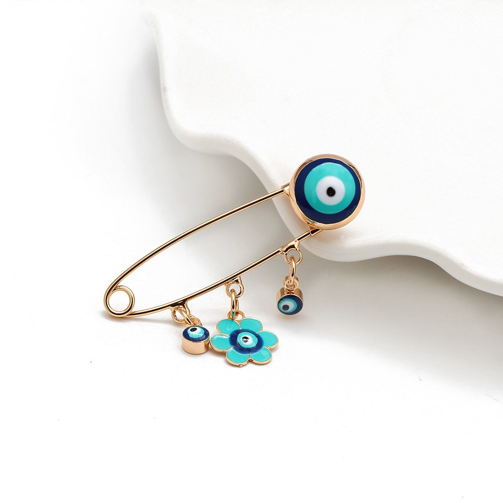 Ward off Bad Luck with our Turkish Evil Eye Brooch Pin with Flower Crown, Hamsa Hand, and Star Charms